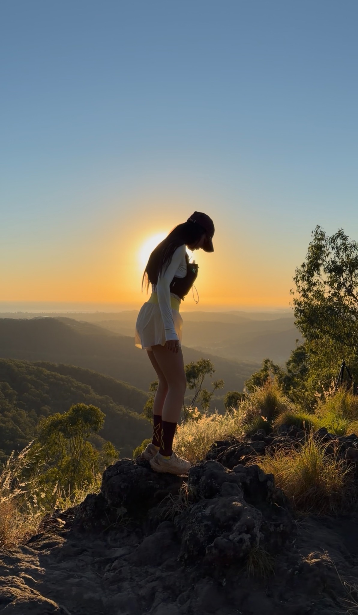 Brooke at sunrise on a mountain